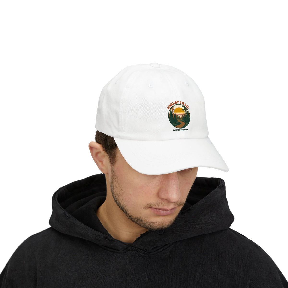 Man in a black hoodie wearing the Forest Trail dad cap in white